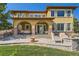 Expansive backyard with a stone patio, hot tub, and an outdoor seating area perfect for entertaining guests at 10631 Autumnsong Ct, Highlands Ranch, CO 80126