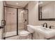Modern bathroom featuring a tiled shower with glass doors and a sleek vanity with a rectangular mirror at 10631 Autumnsong Ct, Highlands Ranch, CO 80126
