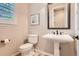 Elegant powder room features a pedestal sink, decorative mirror, and a classic design at 10631 Autumnsong Ct, Highlands Ranch, CO 80126