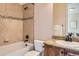 Bright bathroom featuring a tiled tub with black fixtures and a granite countertop on the vanity sink at 10631 Autumnsong Ct, Highlands Ranch, CO 80126
