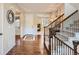 Welcoming foyer featuring hardwood floors, a staircase, and natural light at 10631 Autumnsong Ct, Highlands Ranch, CO 80126