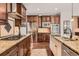 Modern kitchen features granite counters, stainless steel appliances, and dark wood cabinetry at 10631 Autumnsong Ct, Highlands Ranch, CO 80126