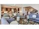 Comfortable seating in living room showcasing an open floorplan to the kitchen at 10631 Autumnsong Ct, Highlands Ranch, CO 80126