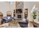 Cozy living room with a striking stone fireplace and comfortable seating at 10631 Autumnsong Ct, Highlands Ranch, CO 80126