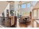 Bright living room showcasing soaring ceilings, a stone fireplace, and large windows at 10631 Autumnsong Ct, Highlands Ranch, CO 80126