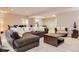 Spacious living room with a large sectional sofa, plush carpet, and open layout perfect for entertaining at 10631 Autumnsong Ct, Highlands Ranch, CO 80126