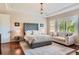 Large primary bedroom featuring tray ceilings, a sitting area, and ample natural light at 10631 Autumnsong Ct, Highlands Ranch, CO 80126