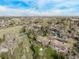 Aerial shows lush neighborhood, green space, and trails near the property at 683 Sunnyside St, Louisville, CO 80027