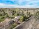 Wide aerial shot of home, neighborhood and surrounding area under blue skies at 683 Sunnyside St, Louisville, CO 80027
