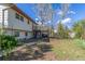 Spacious backyard with mature trees, a two-story home with a deck, and a serene outdoor setting at 683 Sunnyside St, Louisville, CO 80027