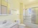 Bright bathroom with a shower-tub combo, accessible grab bars, and a single sink vanity at 683 Sunnyside St, Louisville, CO 80027
