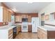 Functional kitchen featuring light cabinets, white countertops, appliances, and ample storage at 683 Sunnyside St, Louisville, CO 80027