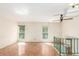 Bright living room offering natural light with wooden floors, stairwell, and ceiling fan at 683 Sunnyside St, Louisville, CO 80027