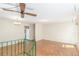 Spacious living room with wooden floors, ceiling fan, and stairwell leading to upper level at 683 Sunnyside St, Louisville, CO 80027