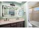 Bathroom featuring double sinks, a large framed mirror, vanity, and a separated tub at 16277 Blueleaf Pl, Parker, CO 80134