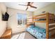 bedroom featuring a bunk bed, mounted TV and a window overlooking the backyard at 16277 Blueleaf Pl, Parker, CO 80134