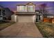 Charming two-story home with a well-maintained lawn and a two-car garage at 16277 Blueleaf Pl, Parker, CO 80134