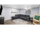 Cozy living room with plush gray sectional sofa and decorative rug on wood floors at 16277 Blueleaf Pl, Parker, CO 80134