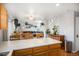 Open floor plan with an island that connects the kitchen and the living room at 16277 Blueleaf Pl, Parker, CO 80134