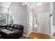 Bright entryway with hardwood floors, a brown leather sofa, and a staircase at 16277 Blueleaf Pl, Parker, CO 80134
