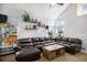Large living area with a plush sofa, a wooden coffee table, and natural lighting at 16277 Blueleaf Pl, Parker, CO 80134