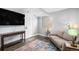 Comfortable living room with gray sofa, colorful rug, and stylish floor lamp at 16277 Blueleaf Pl, Parker, CO 80134