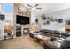 Spacious living room with a fireplace, large TV, and comfortable seating area at 16277 Blueleaf Pl, Parker, CO 80134