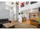 Open-concept living area with high ceilings, hardwood floors, and modern decor at 16277 Blueleaf Pl, Parker, CO 80134