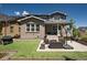 Spacious backyard patio with a seating area, artificial turf, and a view of the home's exterior at 8102 Adams Fork Ave, Littleton, CO 80125
