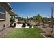 Inviting backyard patio with artificial turf, seating area, and landscaped surroundings at 8102 Adams Fork Ave, Littleton, CO 80125