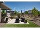 Picturesque backyard patio with cozy seating, a well-kept lawn, and charming landscaping at 8102 Adams Fork Ave, Littleton, CO 80125