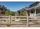 Serene backyard view with a wooden fence, manicured landscaping, and mountain vistas at 8102 Adams Fork Ave, Littleton, CO 80125