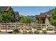 Scenic street view featuring lush landscaping, charming fences, and mountain views in the distance at 8102 Adams Fork Ave, Littleton, CO 80125