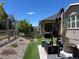 Inviting backyard oasis with artificial turf, stone patio, outdoor seating, and a lush, private garden at 8102 S Adams Fork Ave, Littleton, CO 80125