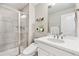 Modern bathroom featuring a sleek vanity with a sink and a glass-enclosed shower at 8102 S Adams Fork Ave, Littleton, CO 80125