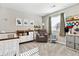 Bright Bedroom with a crib, changing table, comfortable chair, and charming decor at 8102 S Adams Fork Ave, Littleton, CO 80125