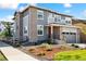 Stunning two-story home with a two car garage, well-manicured landscaping, and gray and brick accents at 8102 S Adams Fork Ave, Littleton, CO 80125