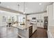 Bright kitchen featuring a large island with a granite countertop, stainless steel appliances, and pendant lighting at 8102 S Adams Fork Ave, Littleton, CO 80125