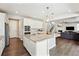 Bright kitchen features a large island with granite countertops and stainless steel appliances at 8102 S Adams Fork Ave, Littleton, CO 80125