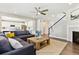 Open-concept living room with an accent fireplace, a large sectional, and hardwood floors at 8102 S Adams Fork Ave, Littleton, CO 80125