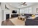 Comfortable living room featuring a fireplace, a large gray sectional, and hardwood floors at 8102 S Adams Fork Ave, Littleton, CO 80125