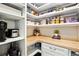 Organized walk-in pantry with custom shelves and butcher block countertop at 8102 S Adams Fork Ave, Littleton, CO 80125