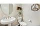 Charming powder room with pedestal sink, stylish accents and decor at 8102 S Adams Fork Ave, Littleton, CO 80125