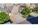Aerial view of home with stone accents, a driveway, and a well-maintained front yard at 12652 Glencoe St, Thornton, CO 80241