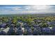 An aerial view of the neighborhood showcasing the well-maintained homes and tree-lined streets under a clear blue sky at 12652 Glencoe St, Thornton, CO 80241