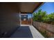 Covered back patio with view of wood fence and green space at 12652 Glencoe St, Thornton, CO 80241