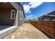A view of the backyard, enclosed by a wooden fence, offering privacy and space for outdoor activities and landscaping at 12652 Glencoe St, Thornton, CO 80241
