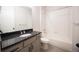 Bathroom with granite countertop and tiled shower at 12652 Glencoe St, Thornton, CO 80241