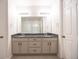 Bathroom features a dual vanity with granite countertop and tiled flooring at 12652 Glencoe St, Thornton, CO 80241
