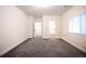 Large bedroom with new carpets, a closet and two doorways at 12652 Glencoe St, Thornton, CO 80241